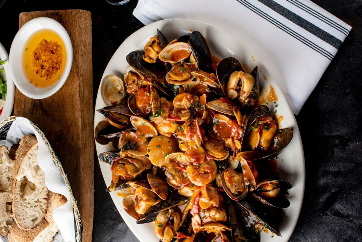 seafood dish containing mussels and shrimp with bread