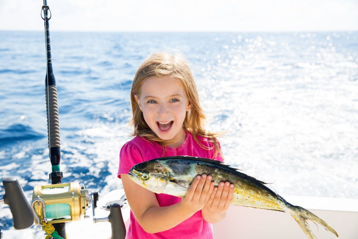 girl on fishing boat with fish